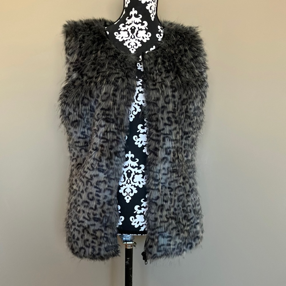 Fuzzy animal print vest with zip front.